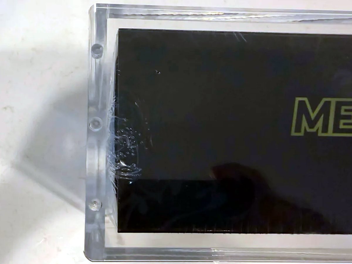 Top view of a Mega Charizard X UPC case showing the thick acrylic edge and recessed lid magnets